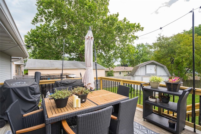 729 SE 3rd St, Ankeny, IA 50021 - wooden deck featuring outdoor dining space, a grill, and a storage unit