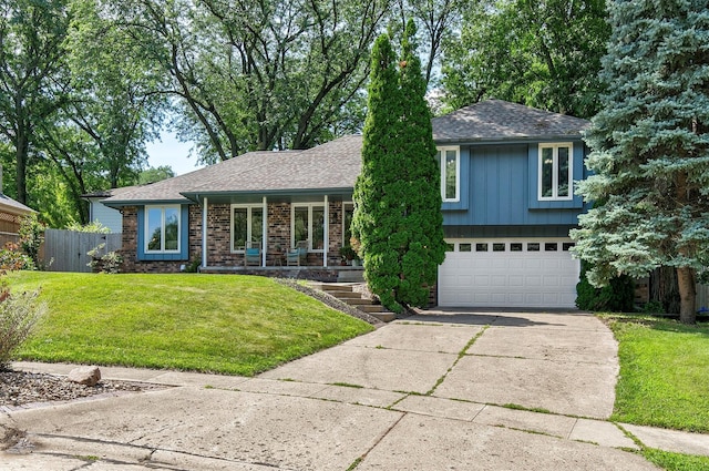 10438 Donna Bella Cir, Clive, IA 50325 - split level home with an attached garage, driveway, a shingled roof, a porch, and brick siding