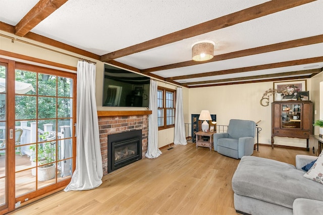 10438 Donna Bella Cir, Clive, IA 50325 - living area with beam ceiling, a brick fireplace, and wood finished floors