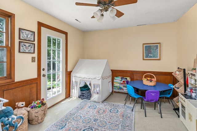 10438 Donna Bella Cir, Clive, IA 50325 - playroom with carpet, wainscoting, and a ceiling fan