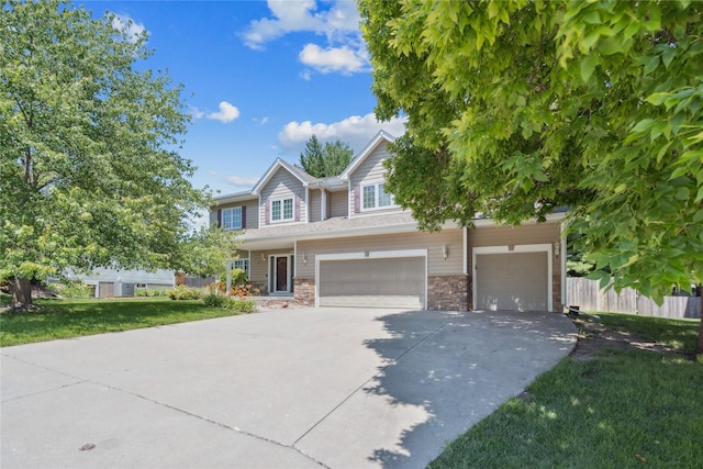 303 Trevor Ct, Norwalk, IA 50211 - multi unit property featuring driveway, a garage, and stone siding