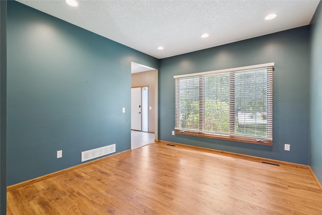 303 Trevor Ct, Norwalk, IA 50211 - empty room with wood finished floors, recessed lighting, and a textured ceiling