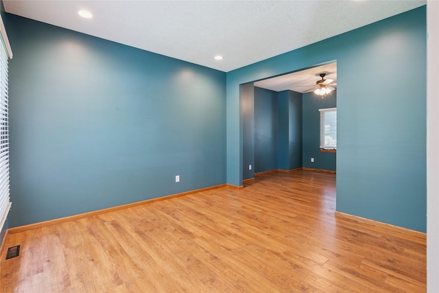 303 Trevor Ct, Norwalk, IA 50211 - spare room featuring wood finished floors, ceiling fan, and recessed lighting
