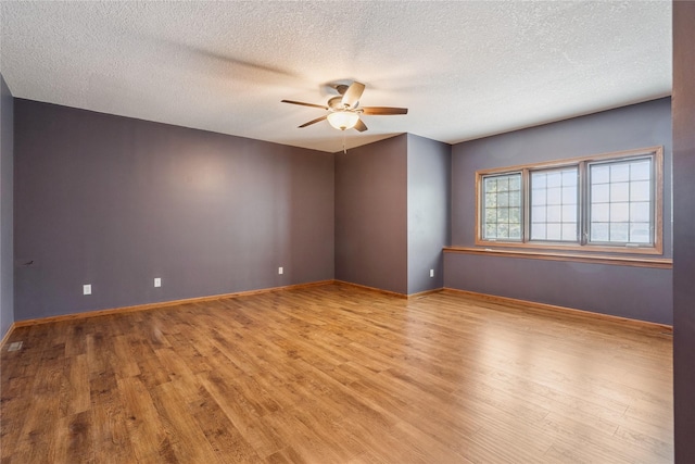 303 Trevor Ct, Norwalk, IA 50211 - empty room featuring ceiling fan, wood finished floors, and a textured ceiling
