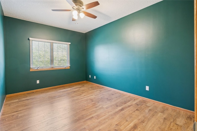 303 Trevor Ct, Norwalk, IA 50211 - empty room featuring a ceiling fan, wood finished floors, and a textured ceiling