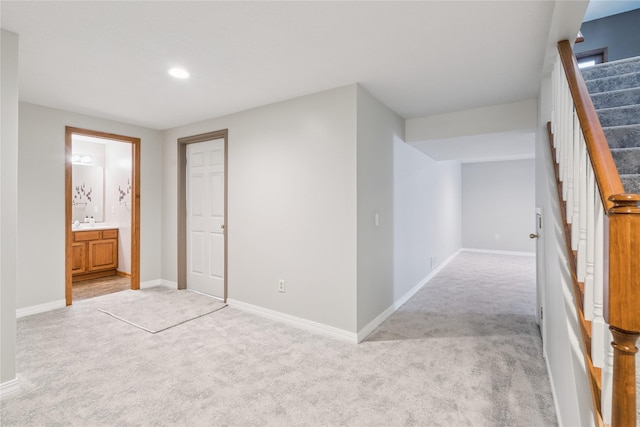 303 Trevor Ct, Norwalk, IA 50211 - hall with light colored carpet, stairway, and recessed lighting