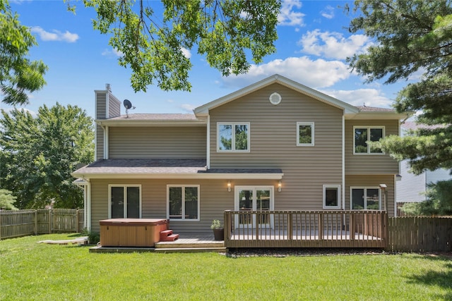 303 Trevor Ct, Norwalk, IA 50211 - back of house featuring a hot tub, a fenced backyard, a deck, and a chimney