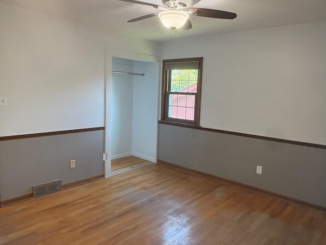 3909 75th St, Urbandale, IA 50322 - empty room with wood finished floors and ceiling fan