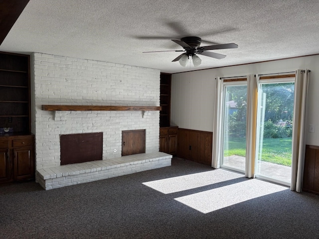 3909 75th St, Urbandale, IA 50322 - unfurnished living room featuring a brick fireplace, plenty of natural light, carpet floors, ceiling fan, and wood walls