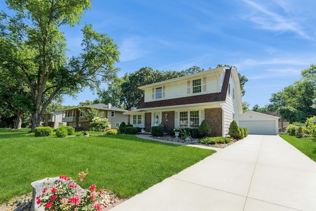 4511 67th St, Urbandale, IA 50322 - traditional-style house with an outdoor structure, brick siding, a front yard, and a garage