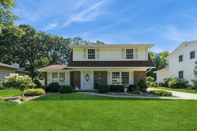 4511 67th St, Urbandale, IA 50322 - traditional-style home featuring a front yard, brick siding, and a shingled roof