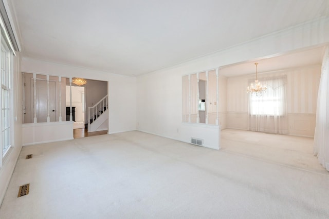4511 67th St, Urbandale, IA 50322 - unfurnished room with a chandelier, carpet flooring, stairs, and crown molding