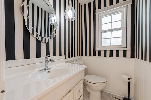 4511 67th St, Urbandale, IA 50322 - half bathroom with a wainscoted wall, wallpapered walls, and vanity