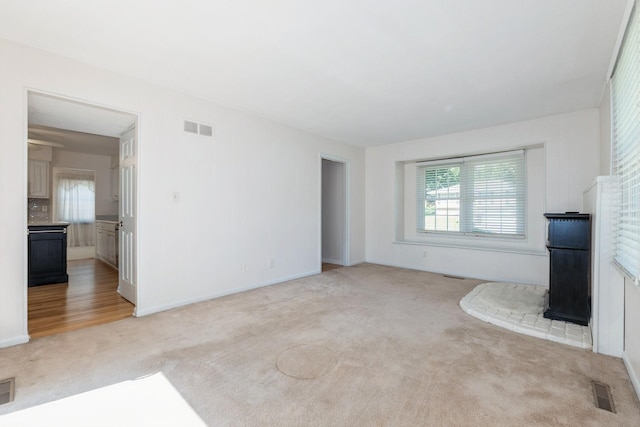 4511 67th St, Urbandale, IA 50322 - unfurnished living room with light colored carpet and baseboards