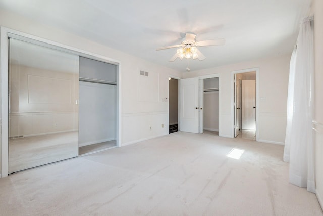 4511 67th St, Urbandale, IA 50322 - unfurnished bedroom with two closets, light carpet, and ceiling fan