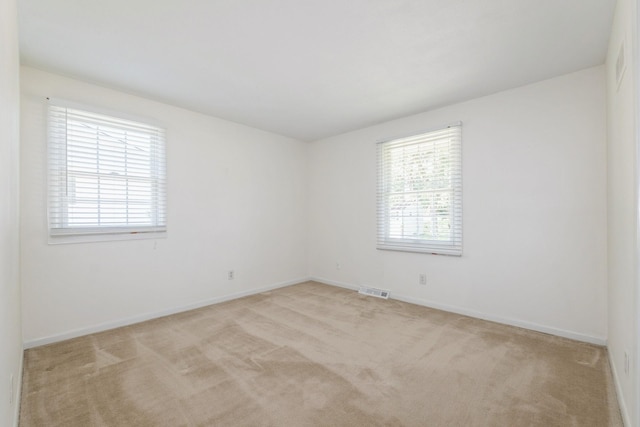 4511 67th St, Urbandale, IA 50322 - spare room featuring light carpet and baseboards