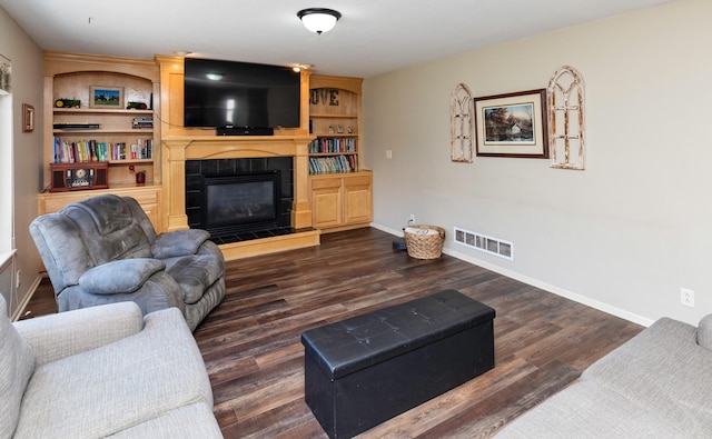 1695 Pease Dr, Pleasant Hill, IA 50327 - living area with a tile fireplace and dark wood-style flooring