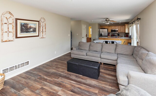 1695 Pease Dr, Pleasant Hill, IA 50327 - living area with dark wood finished floors and a ceiling fan