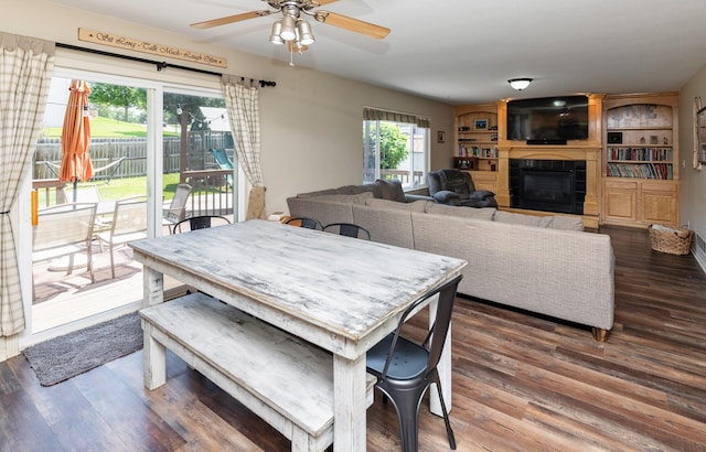 1695 Pease Dr, Pleasant Hill, IA 50327 - dining space with ceiling fan, wood finished floors, and a tile fireplace