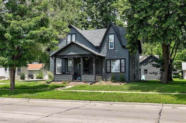 404 W Salem Ave, Indianola, IA 50125 - view of front of property with covered porch, a front lawn, and roof with shingles