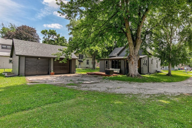 404 W Salem Ave, Indianola, IA 50125 - rear view of house featuring driveway, a yard, a shingled roof, and a deck