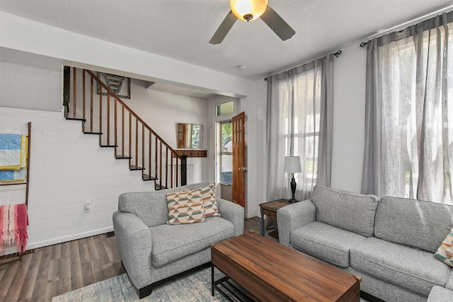 404 W Salem Ave, Indianola, IA 50125 - living area featuring wood finished floors, a ceiling fan, stairway, and a textured ceiling