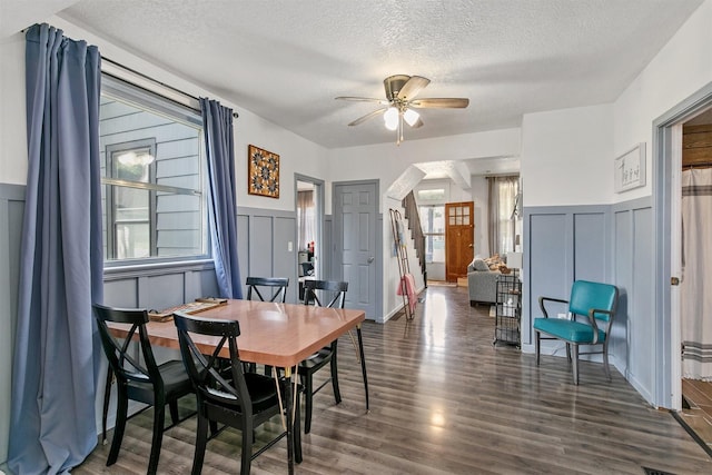 404 W Salem Ave, Indianola, IA 50125 - dining area with a decorative wall, a textured ceiling, ceiling fan, wood finished floors, and wainscoting