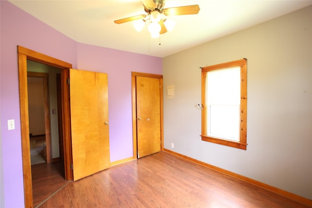 24388 250th St, Eldora, IA 50627 - unfurnished bedroom featuring wood finished floors, a closet, and ceiling fan