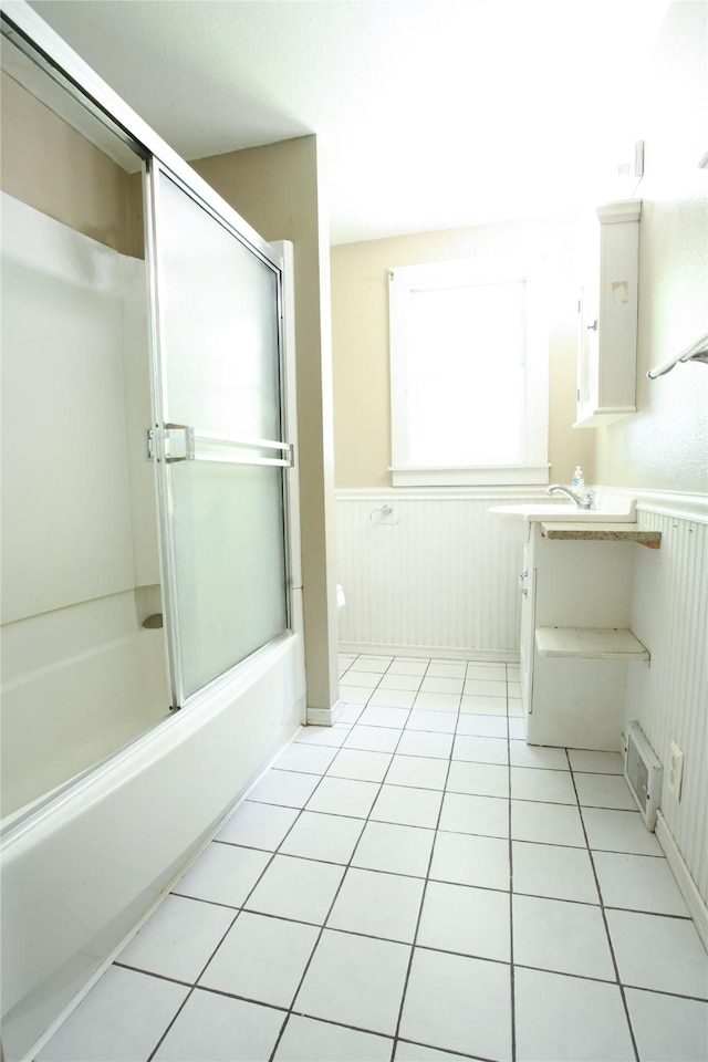 24388 250th St, Eldora, IA 50627 - full bathroom with wainscoting, vanity, tile patterned floors, and combined bath / shower with glass door