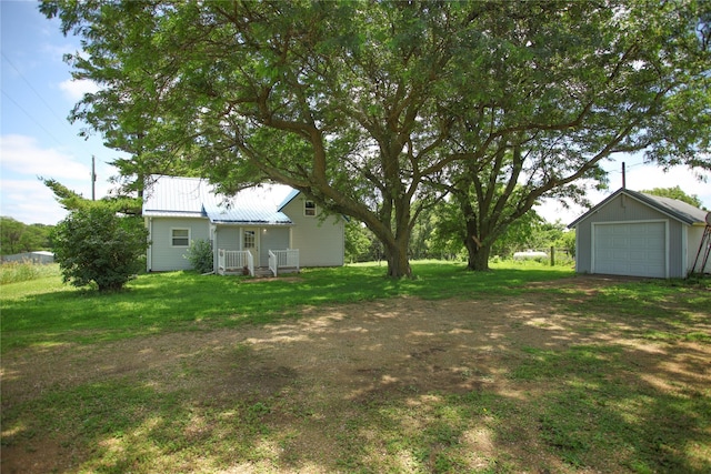 24388 250th St, Eldora, IA 50627 - view of green lawn with a detached garage and an outbuilding