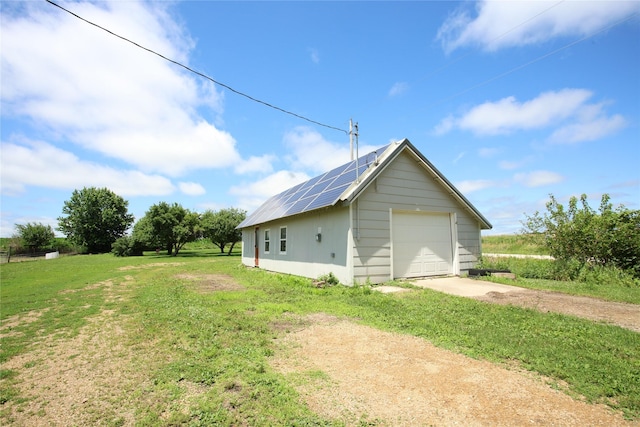 24388 250th St, Eldora, IA 50627 - detached garage with concrete driveway and roof mounted solar panels
