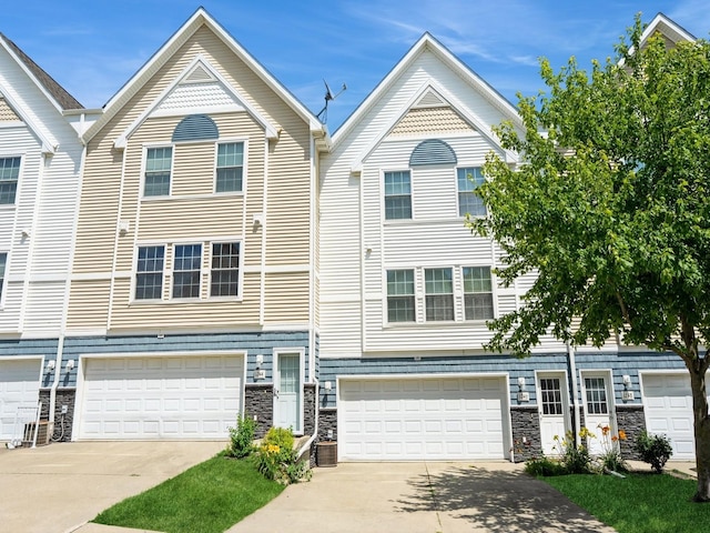 1246 SE Village View Ln, Ankeny, IA 50021 - view of front of home with concrete driveway, an attached garage, and stone siding