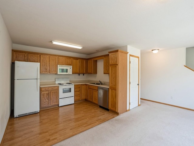 1246 SE Village View Ln, Ankeny, IA 50021 - kitchen with white appliances, light countertops, brown cabinetry, and light wood-type flooring