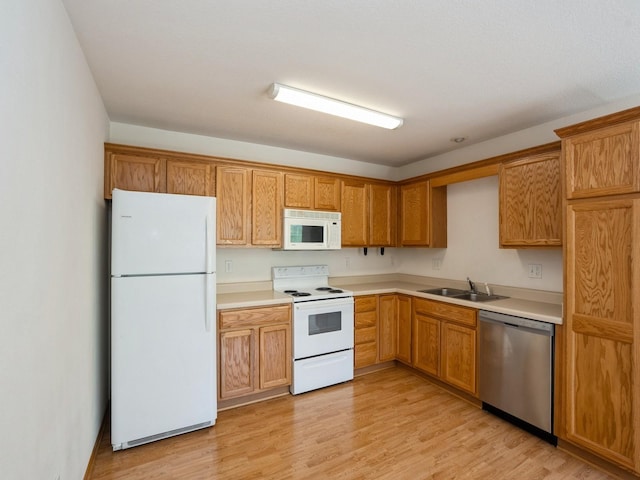 1246 SE Village View Ln, Ankeny, IA 50021 - kitchen featuring white appliances, light wood finished floors, and light countertops