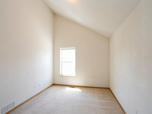 1246 SE Village View Ln, Ankeny, IA 50021 - spare room featuring light carpet and lofted ceiling