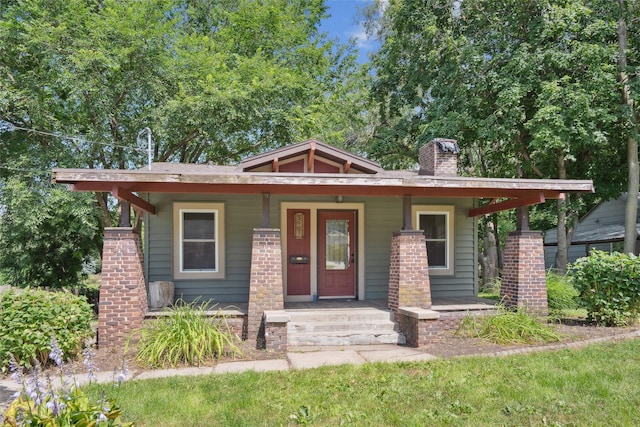 3907 50th St, Des Moines, IA 50310 - view of front of house featuring a porch and a chimney