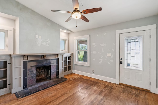 3907 50th St, Des Moines, IA 50310 - unfurnished living room with vaulted ceiling, hardwood / wood-style flooring, a fireplace, plenty of natural light, and ceiling fan