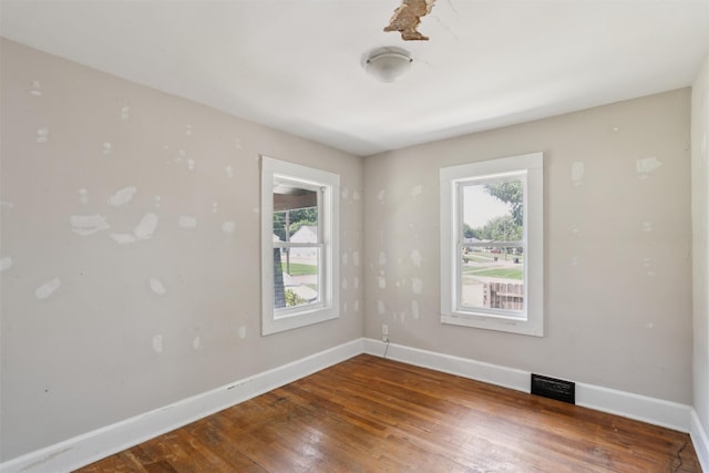 3907 50th St, Des Moines, IA 50310 - empty room with plenty of natural light and hardwood / wood-style flooring