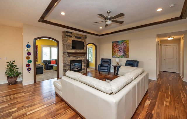 2100 NW Prairie Creek Dr, Grimes, IA 50111 - living room featuring a raised ceiling, arched walkways, recessed lighting, ceiling fan, and wood finished floors