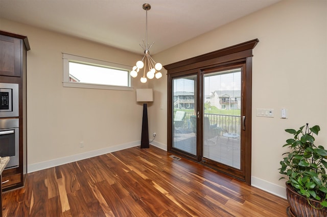 2100 NW Prairie Creek Dr, Grimes, IA 50111 - unfurnished dining area featuring a chandelier, dark wood finished floors, and healthy amount of natural light