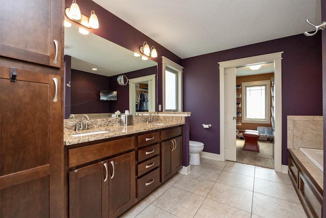 2100 NW Prairie Creek Dr, Grimes, IA 50111 - bathroom with double vanity, tile patterned flooring, and a bathtub