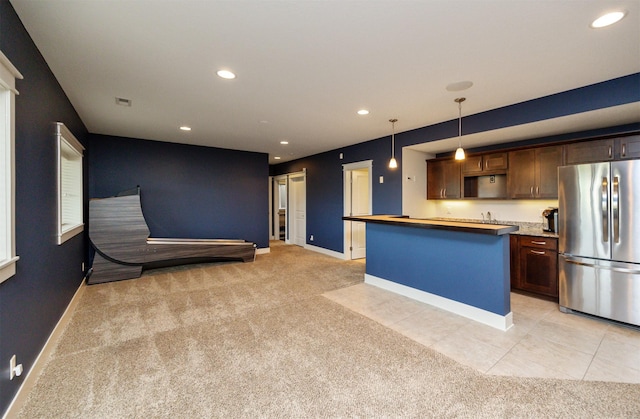 2100 NW Prairie Creek Dr, Grimes, IA 50111 - kitchen featuring freestanding refrigerator, light colored carpet, recessed lighting, and dark brown cabinets