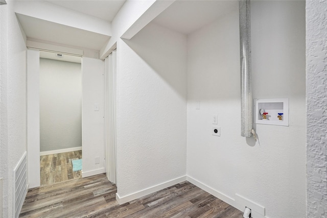 9 1st St, Collins, IA 50055 - washroom featuring electric dryer hookup, hookup for a washing machine, and wood finished floors