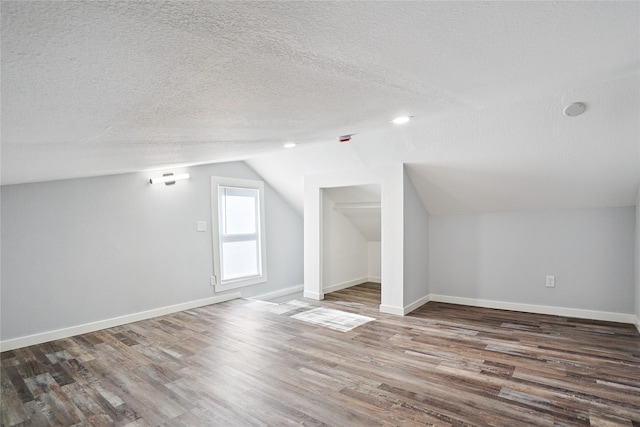 9 1st St, Collins, IA 50055 - additional living space featuring a textured ceiling, wood finished floors, and vaulted ceiling