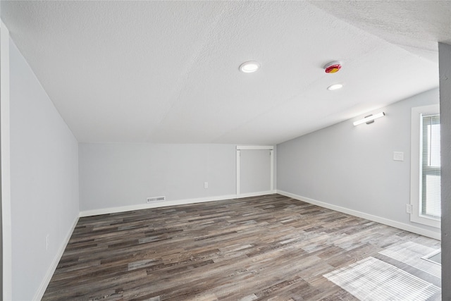 9 1st St, Collins, IA 50055 - additional living space with wood finished floors, recessed lighting, and a textured ceiling