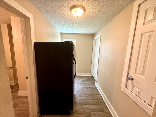 906 Rittenhouse St, Des Moines, IA 50315 - hallway featuring a textured ceiling and dark wood-style floors