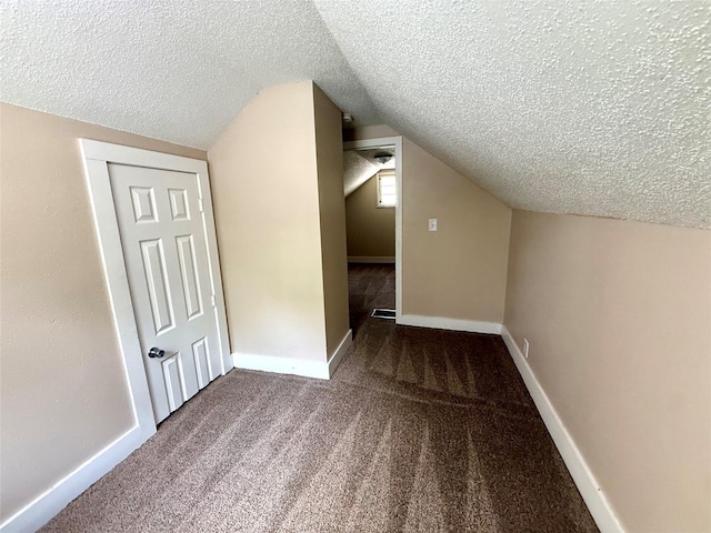 906 Rittenhouse St, Des Moines, IA 50315 - bonus room featuring a textured ceiling, vaulted ceiling, and carpet floors
