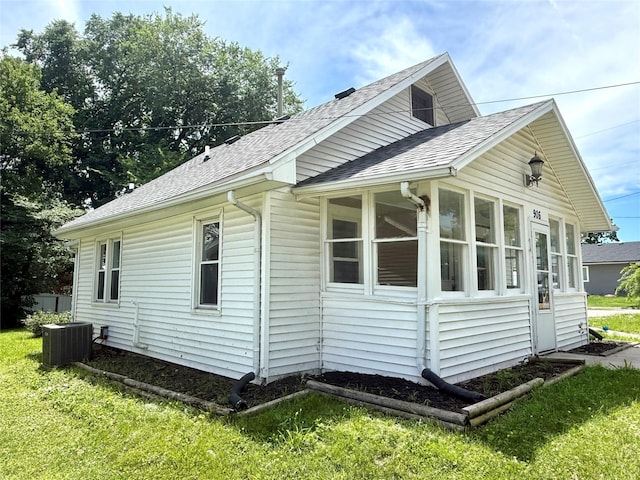 906 Rittenhouse St, Des Moines, IA 50315 - view of property exterior featuring a shingled roof, a sunroom, and a yard
