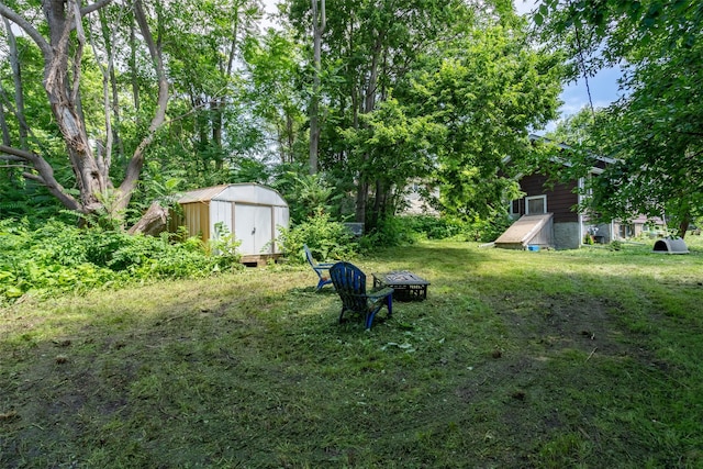 121 Cherry Ave, Ames, IA 50010 - view of yard featuring a storage unit and an outdoor fire pit