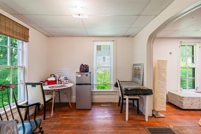 121 Cherry Ave, Ames, IA 50010 - office area featuring a drop ceiling, arched walkways, wood finished floors, and plenty of natural light